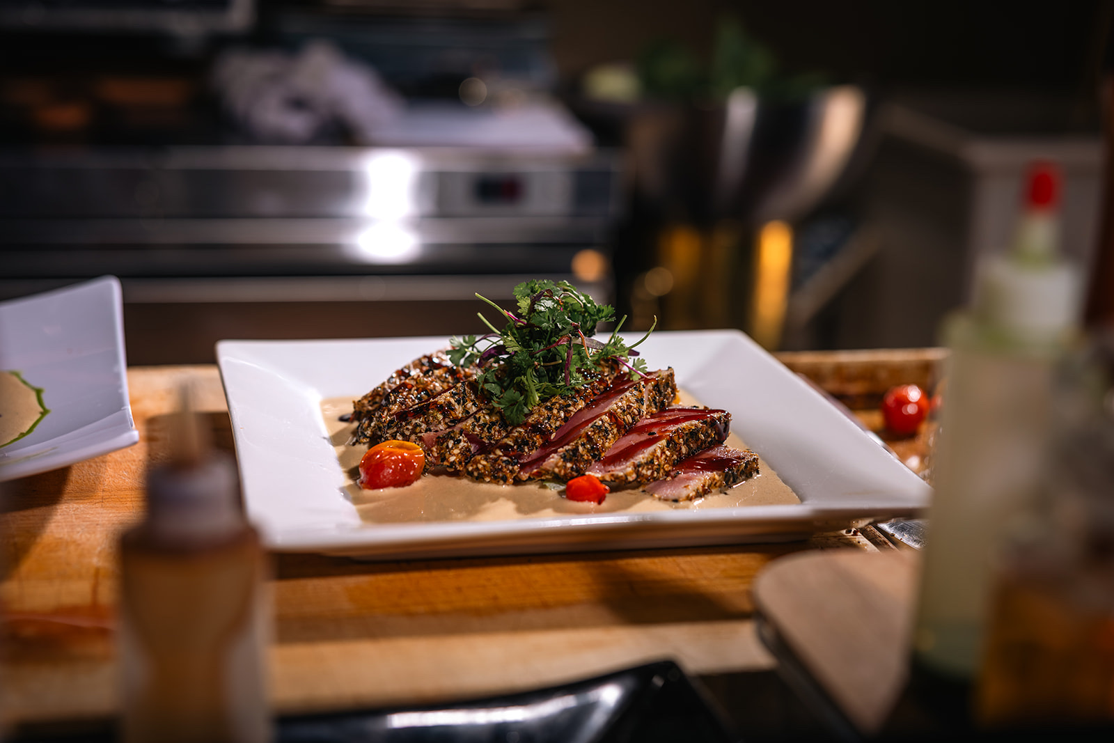 Chef plating a dish, photographed for a Hill Country restaurant brand