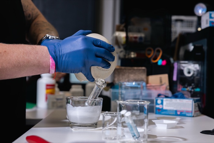 Pharmacist compounding medication by hand in a Texas pharmacy