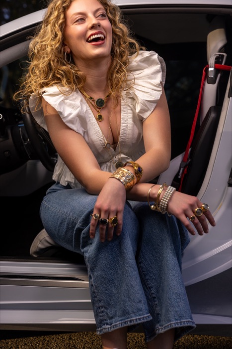 Model wearing handmade jewelry photographed outdoors