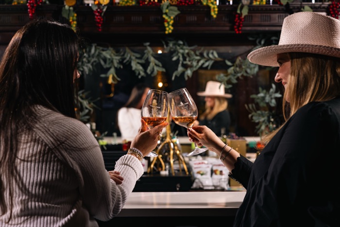 Guests toasting wine glasses in a Texas tasting room