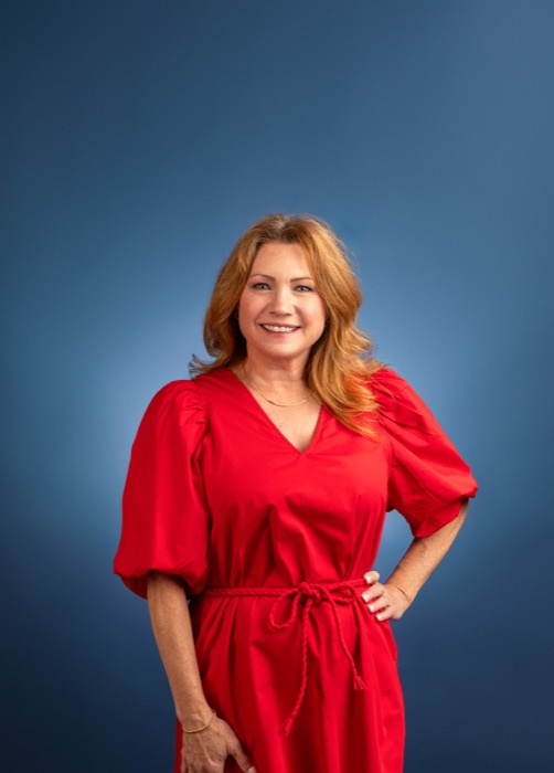 Business portrait photographed on a blue studio backdrop