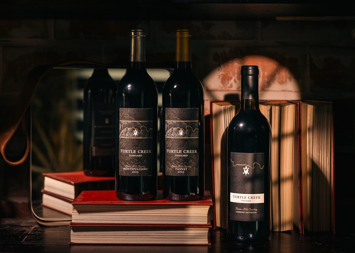 Wine bottle lineup photographed on a dark background